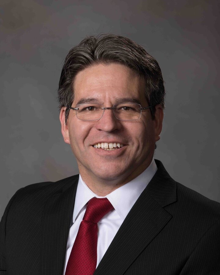 headshot of lance perez against a grey background