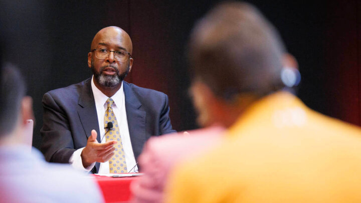 chancellor Bennett talking in front of a crowd of people