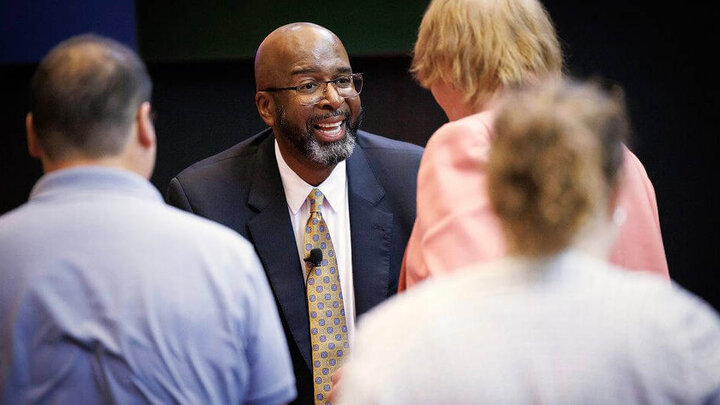 chancellor Bennett smiling and talking to others